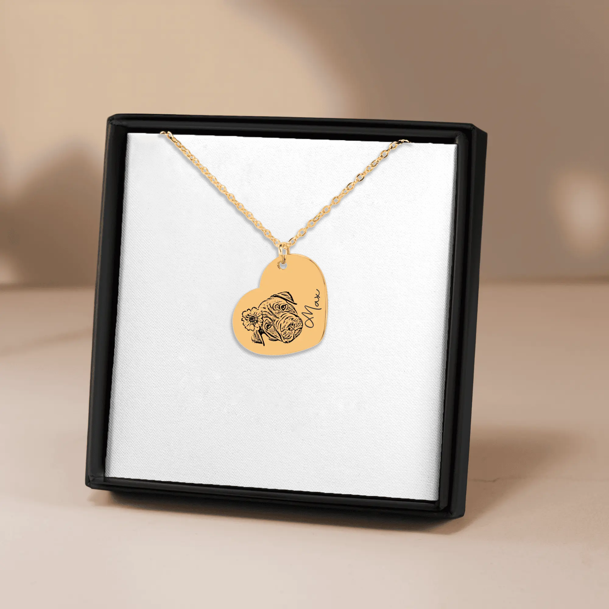 Pet Portrait Heart Necklace: gold heart pendant with a dog portrait engraving on a delicate chain.